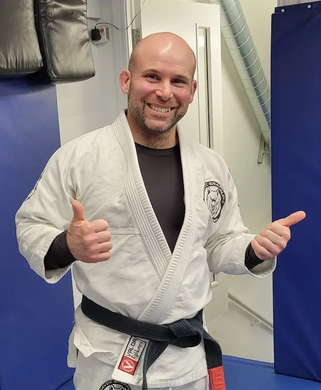 Ben Babbington wearing his Brazilian Jiu-Jitsu black belt and Gi