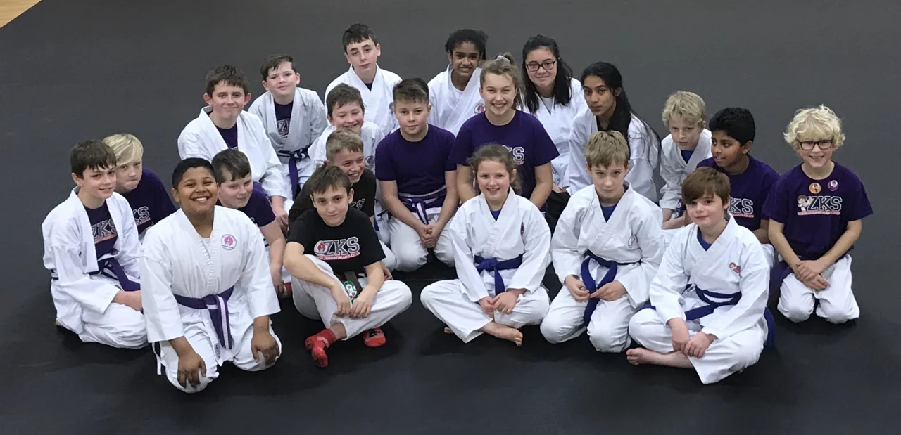 ZKS Junior Martial Arts students with purple and higher belts together on the mats