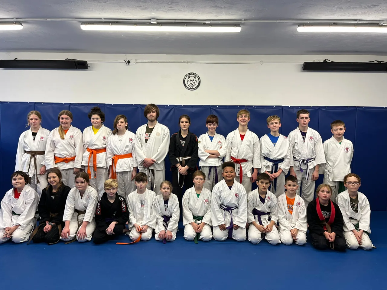 ZKS Teen Martial Arts group wearing a range of coloured belts on the mats