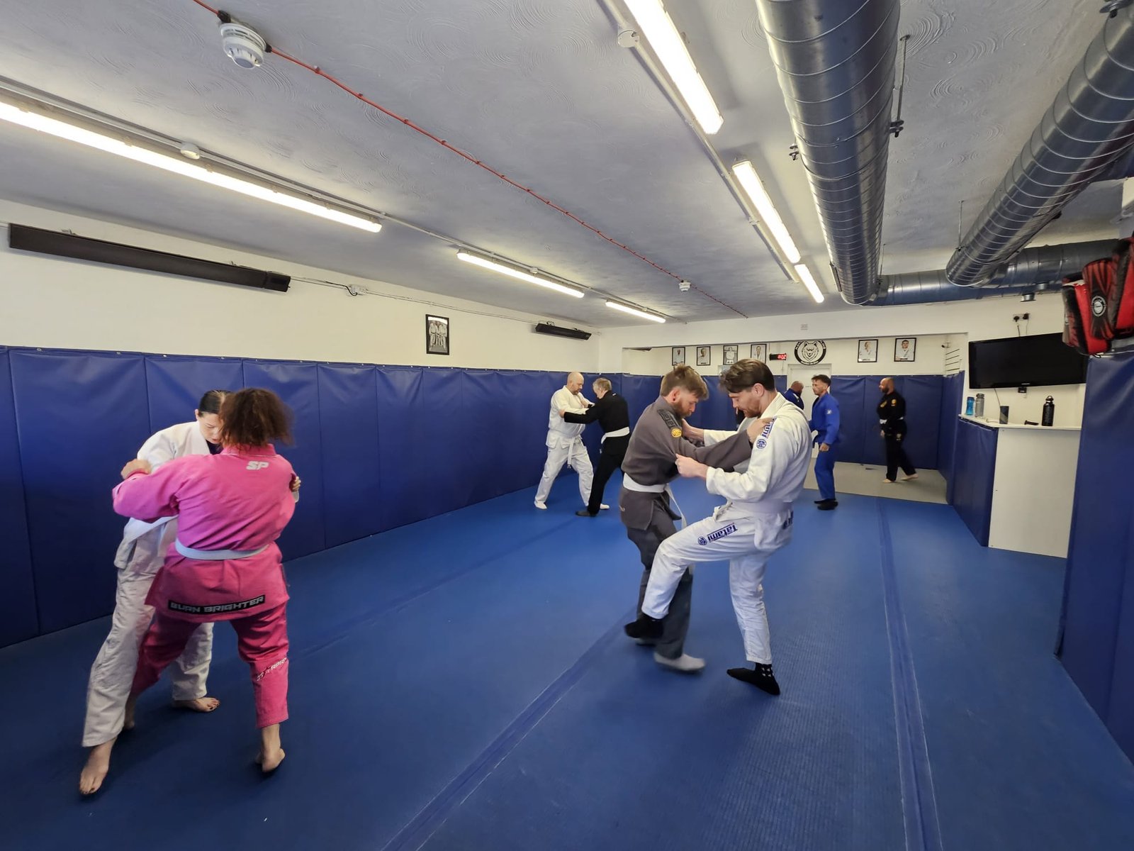 Beginners practising grappling techniques together